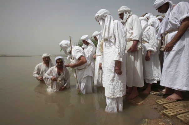 Sabean Mandeans perform baptisms for the faithful, in Iraq's Tigris River. (C) The Washington Post