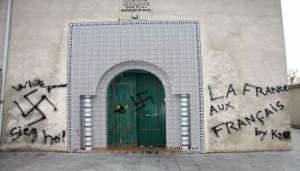 The front door of a mosque in France in 2009, covered by racist and neo-Nazi graffiti. Over the last five years anti-Islam acts have soared in the country, hitting an all-time high in the wake of the terror attack against the weekly satirical newspaper Charlie Hebdo of January 7, 2015. (C) Thierry Antoine/AFP